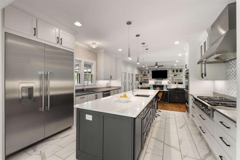 1678 Nottingham Way Northeast Atlanta, GA 30309 - Photo 6 of 57 a kitchen with stainless steel appliances kitchen island a sink stove and refrigerator