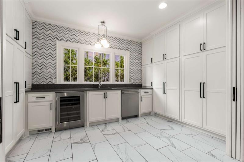 1678 Nottingham Way Northeast Atlanta, GA 30309 - Photo 7 of 57 a kitchen with a stove a sink and a refrigerator