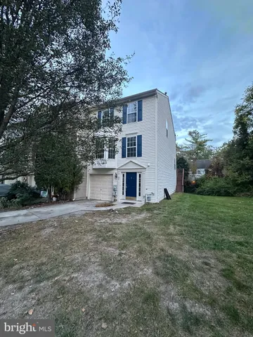 a house with huge green field in front of it