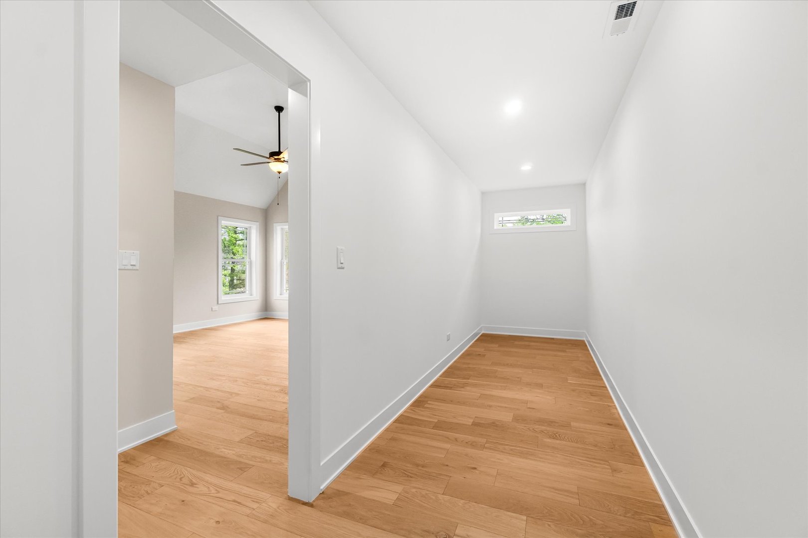 520 North Sleight Street Naperville, IL 60563 - Photo 25 of 51 a view of a hallway with wooden floor and a bathroom