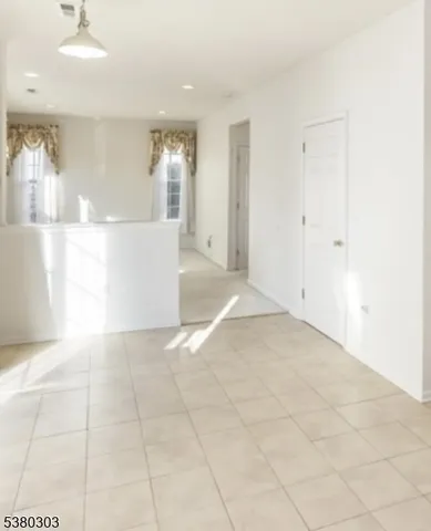a view of a hallway with closet and bathroom