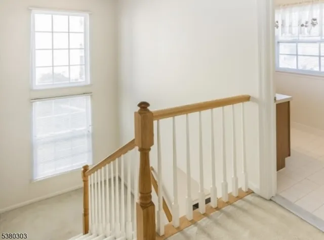 a view of staircase with white walls and windows