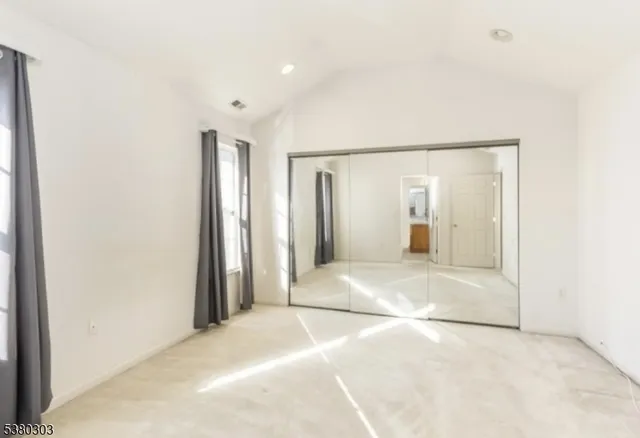 a view of a big room with closet and bathroom