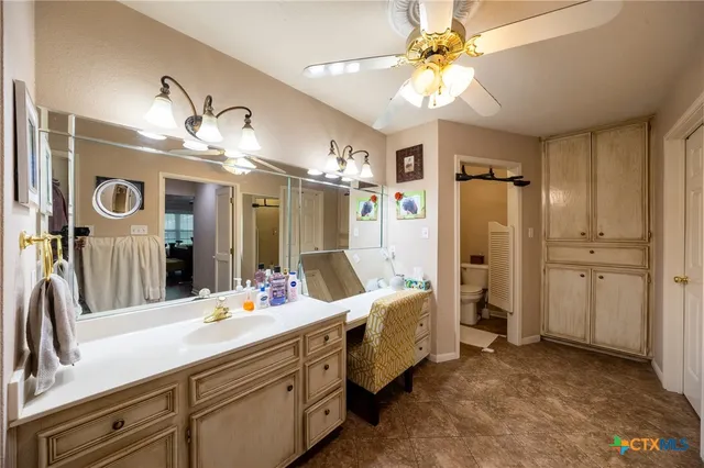 a bathroom with a double vanity sink mirror and shower