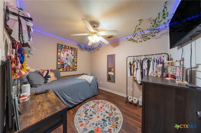 a living room with furniture piano and a chandelier