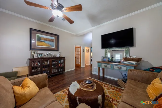 a living room with furniture wooden floor and a chandelier