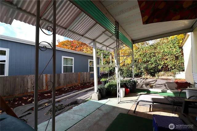 a view of backyard with outdoor seating and barbeque oven