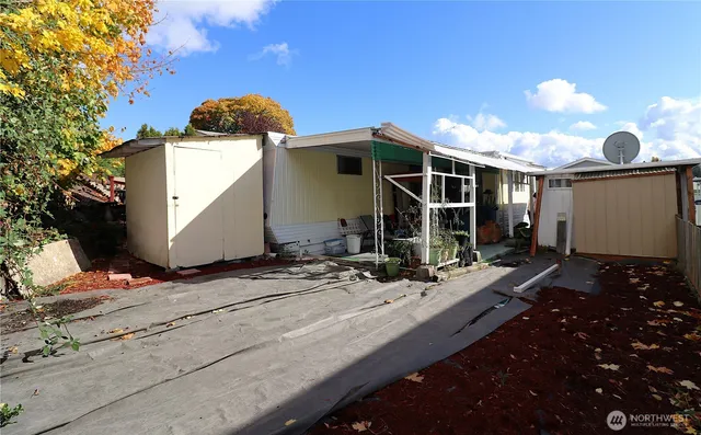 a view of a house with yard and sitting area