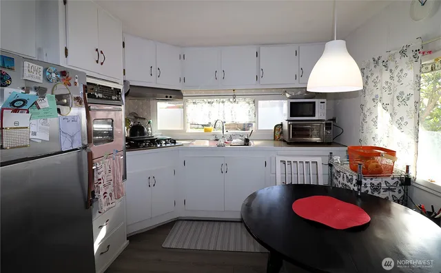 a kitchen with stainless steel appliances granite countertop a sink refrigerator and stove