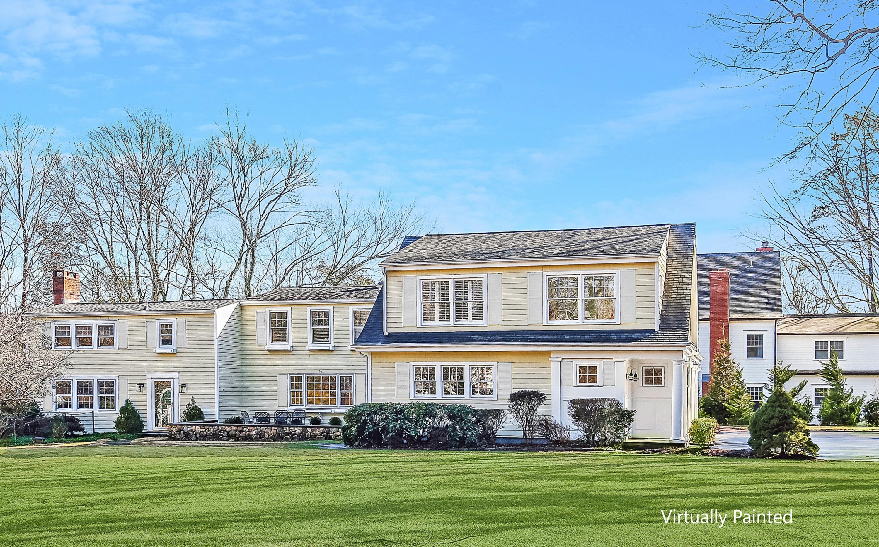 2 Meadowbrook Road Darien, CT 06820 - Photo 3 of 36 a front view of a house with a garden and trees