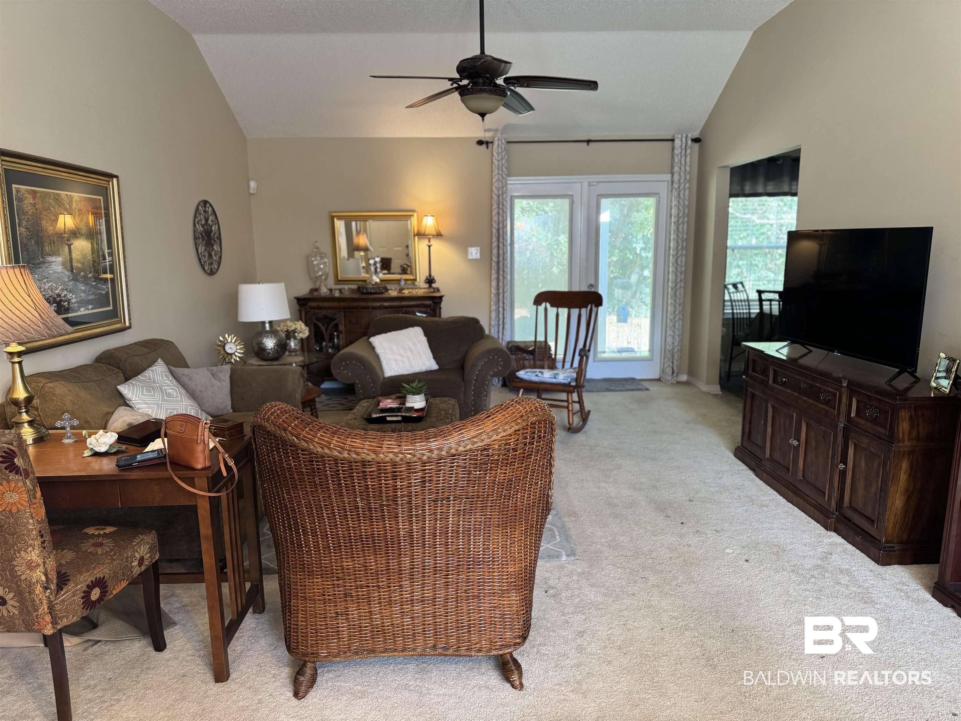 2245 Spring Grove North Mobile, AL 36695 - Photo 2 of 10 Living room featuring light colored carpet, vaulted ceiling, and a ceiling fan