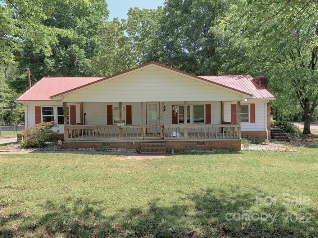 132 Mt Mourne Loop Mooresville, NC 28117 - Photo 1 of 17 a front view of a house with a garden and trees