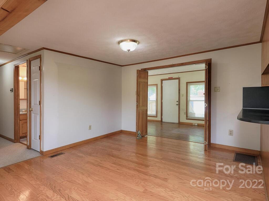 132 Mt Mourne Loop Mooresville, NC 28117 - Photo 4 of 17 a view of an empty room with a window and wooden floor