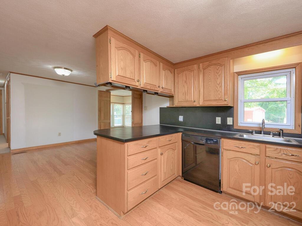 132 Mt Mourne Loop Mooresville, NC 28117 - Photo 5 of 17 a kitchen with granite countertop white cabinets and white appliances