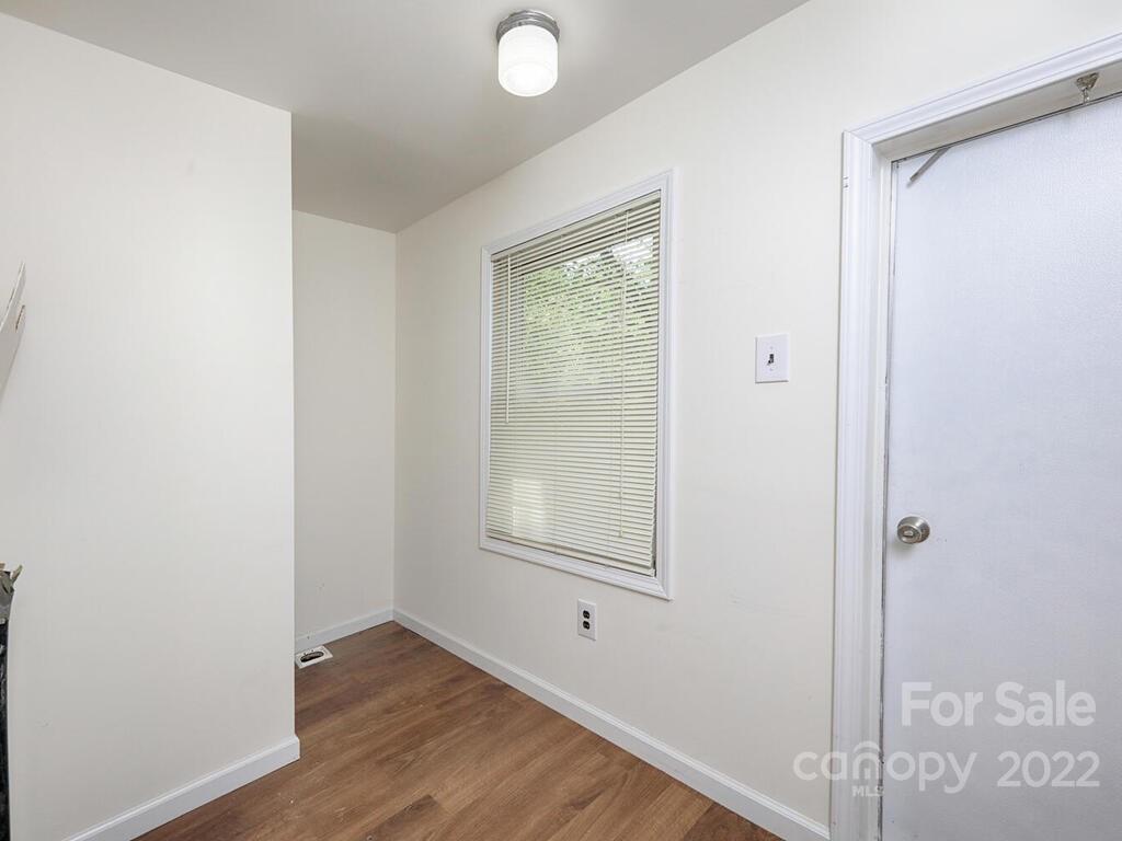 132 Mt Mourne Loop Mooresville, NC 28117 - Photo 7 of 17 a view of an empty room with wooden floor and a window