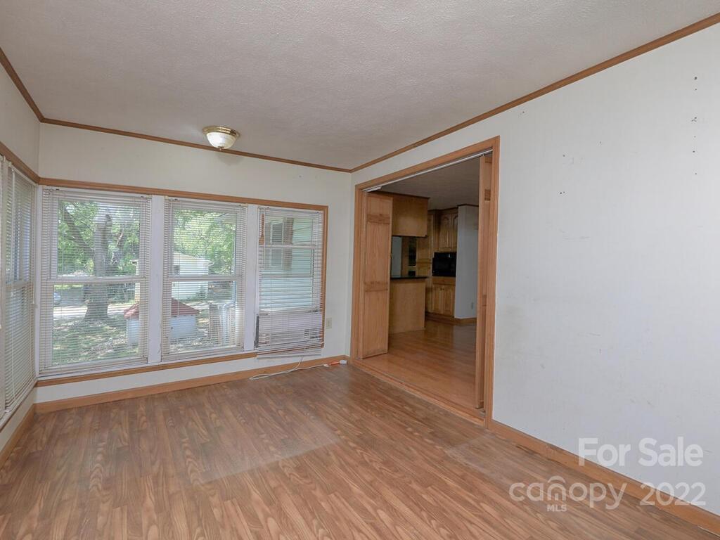 132 Mt Mourne Loop Mooresville, NC 28117 - Photo 8 of 17 a view of an empty room with a window and wooden floor