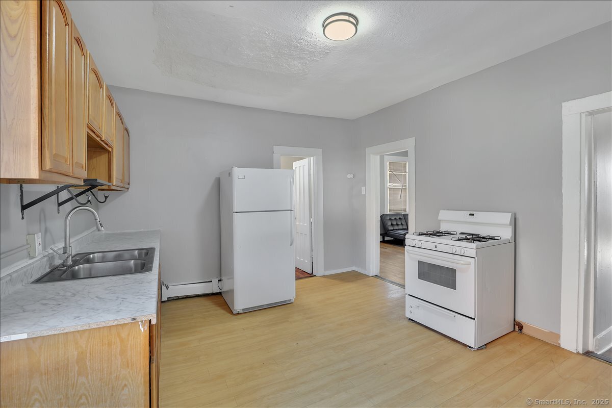 18 Union Street New Britain, CT 06051 - Photo 14 of 24 a kitchen with a sink stove and refrigerator