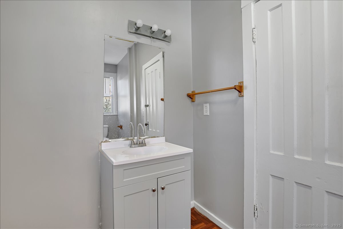 18 Union Street New Britain, CT 06051 - Photo 15 of 24 a bathroom with a sink a mirror and shower