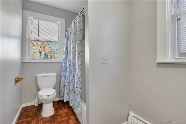 a white toilet sitting next to a bathroom sink