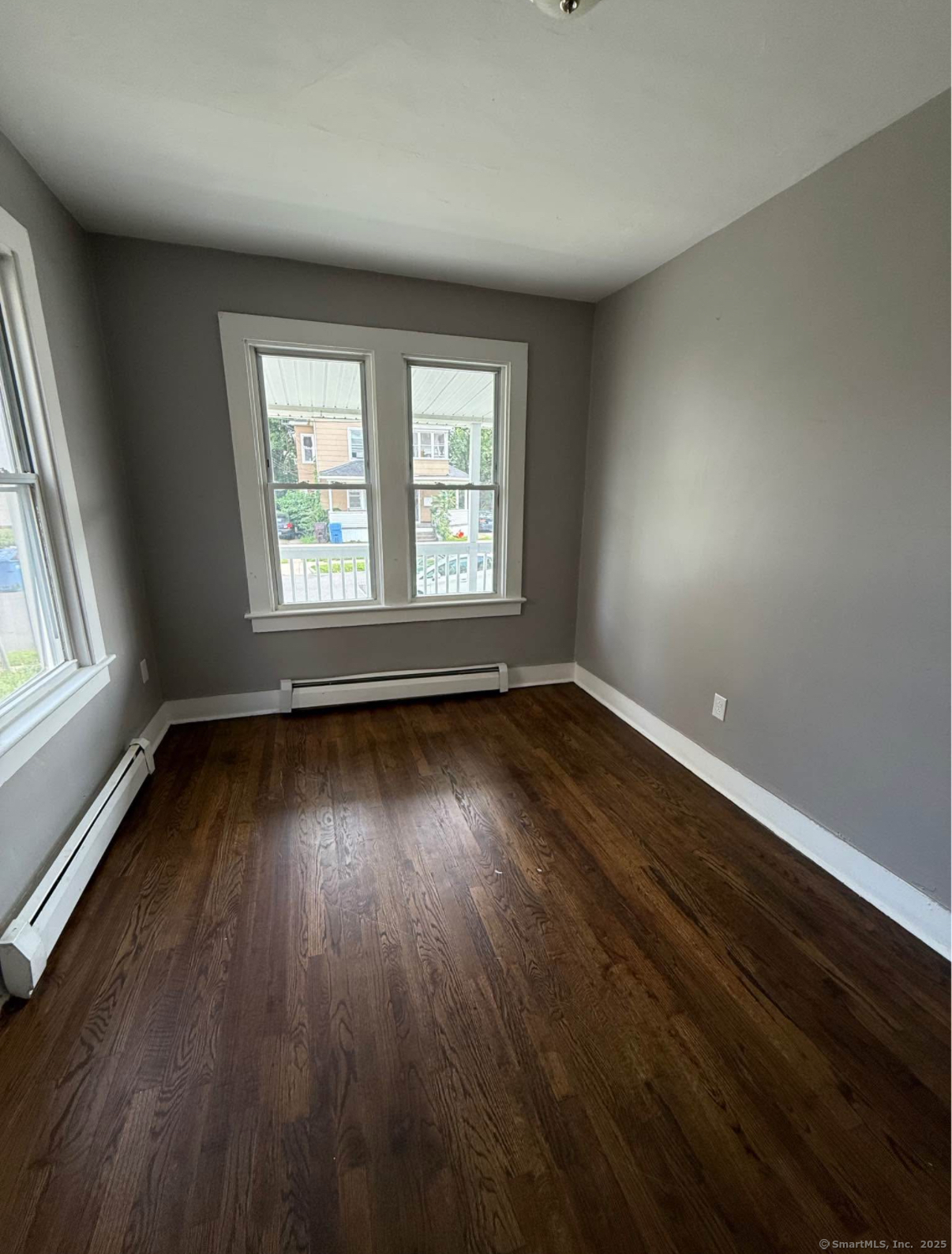 18 Union Street New Britain, CT 06051 - Photo 6 of 24 an empty room with wooden floor and windows