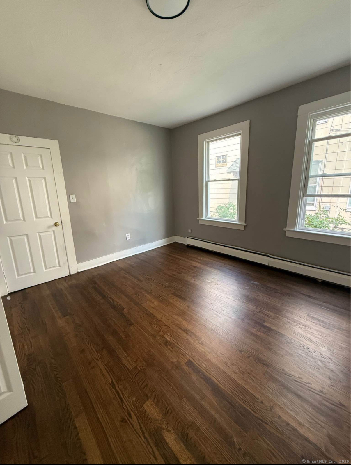 18 Union Street New Britain, CT 06051 - Photo 7 of 24 an empty room with wooden floor and windows