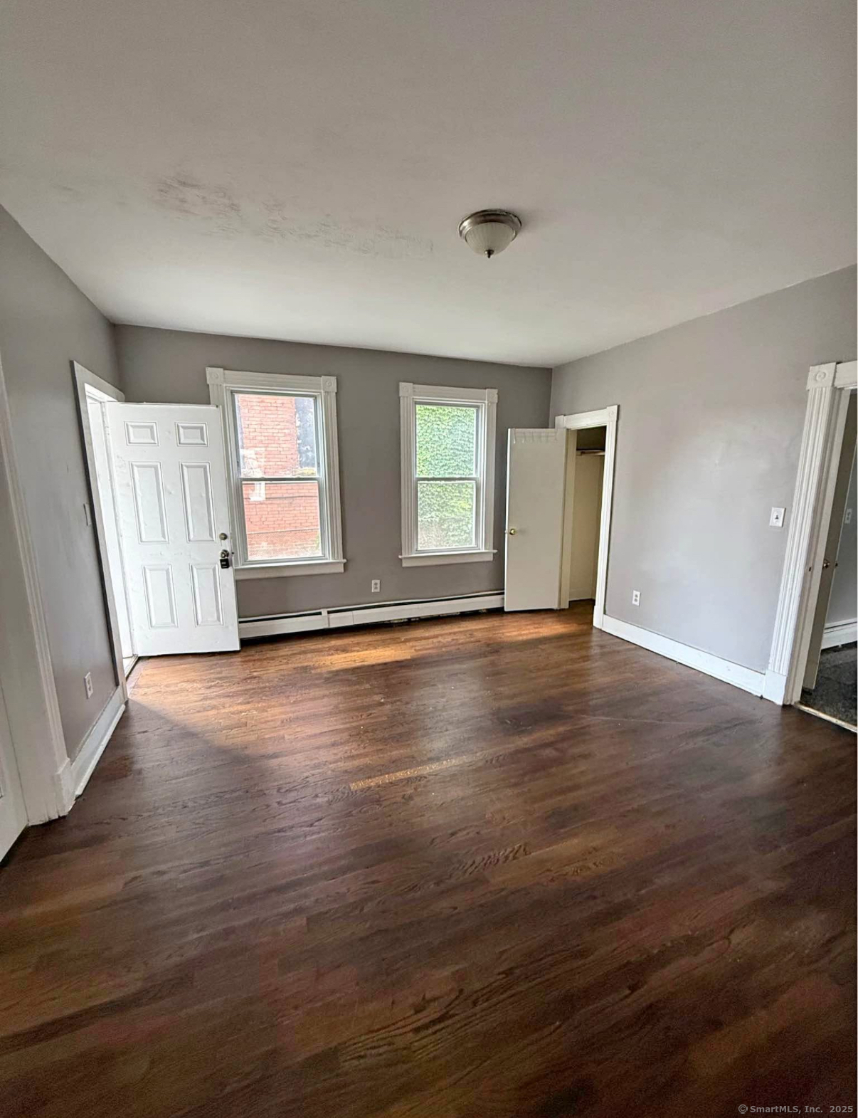 18 Union Street New Britain, CT 06051 - Photo 8 of 24 an empty room with wooden floor and windows