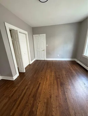wooden floor in a hall with an empty room