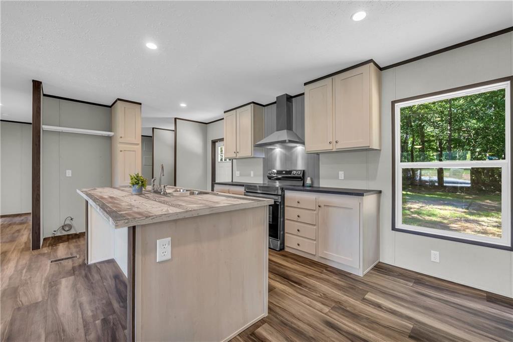 3078 Anderson Highway Hartwell, GA 30643 - Photo 12 of 37 a kitchen with stainless steel appliances granite countertop a sink stove and refrigerator