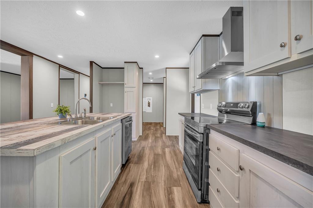 3078 Anderson Highway Hartwell, GA 30643 - Photo 13 of 37 a kitchen with stainless steel appliances granite countertop a sink and cabinets