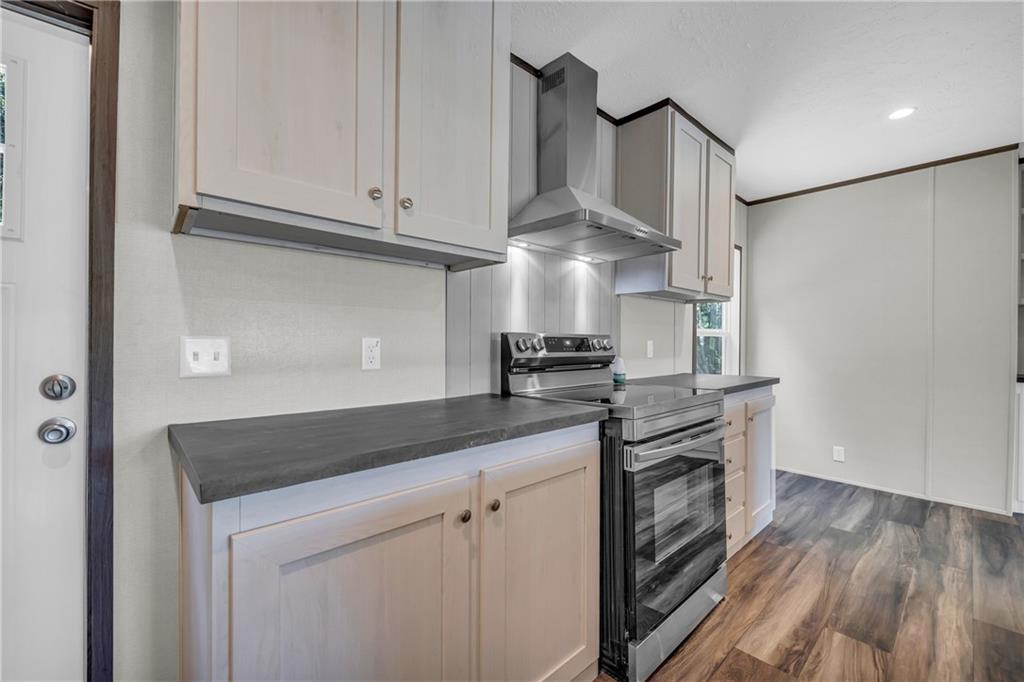 3078 Anderson Highway Hartwell, GA 30643 - Photo 14 of 37 a kitchen with stainless steel appliances granite countertop a sink a stove and a refrigerator