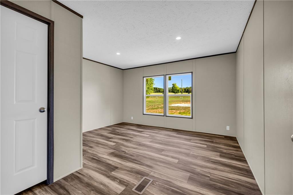 3078 Anderson Highway Hartwell, GA 30643 - Photo 20 of 37 a view of an empty room with a window and wooden floor