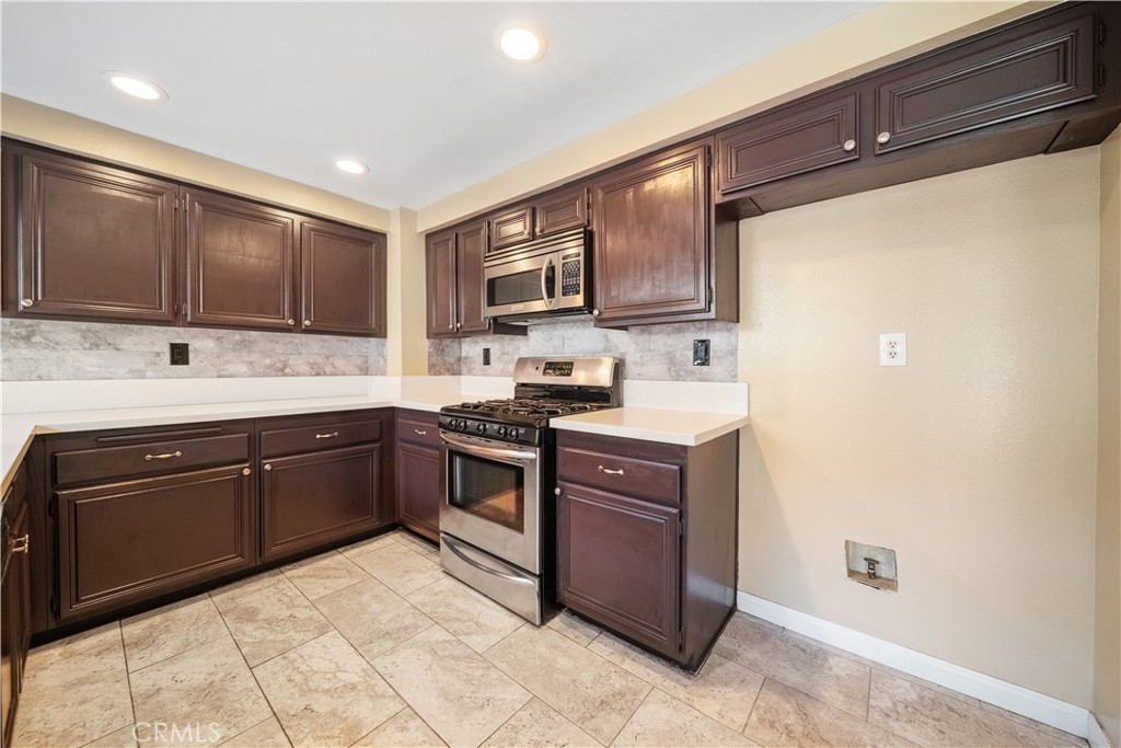3 Saddlewood Lane Pomona, CA 91766 - Photo 11 of 40 a kitchen with granite countertop a refrigerator and a stove top oven