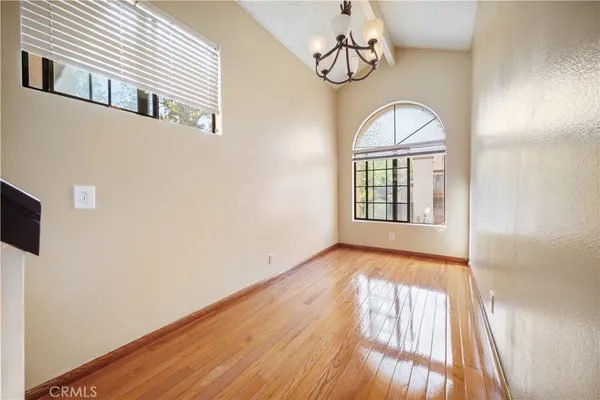 a view of a livingroom with wooden floor and window