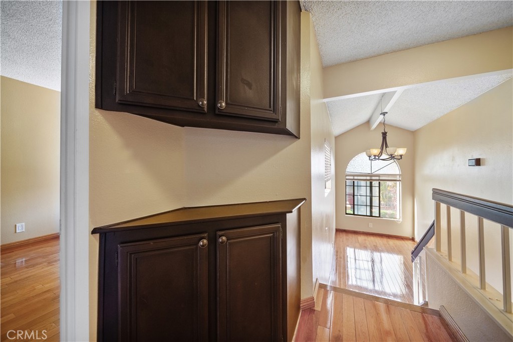 3 Saddlewood Lane Pomona, CA 91766 - Photo 21 of 40 a kitchen with granite countertop wooden cabinets and a stove top oven