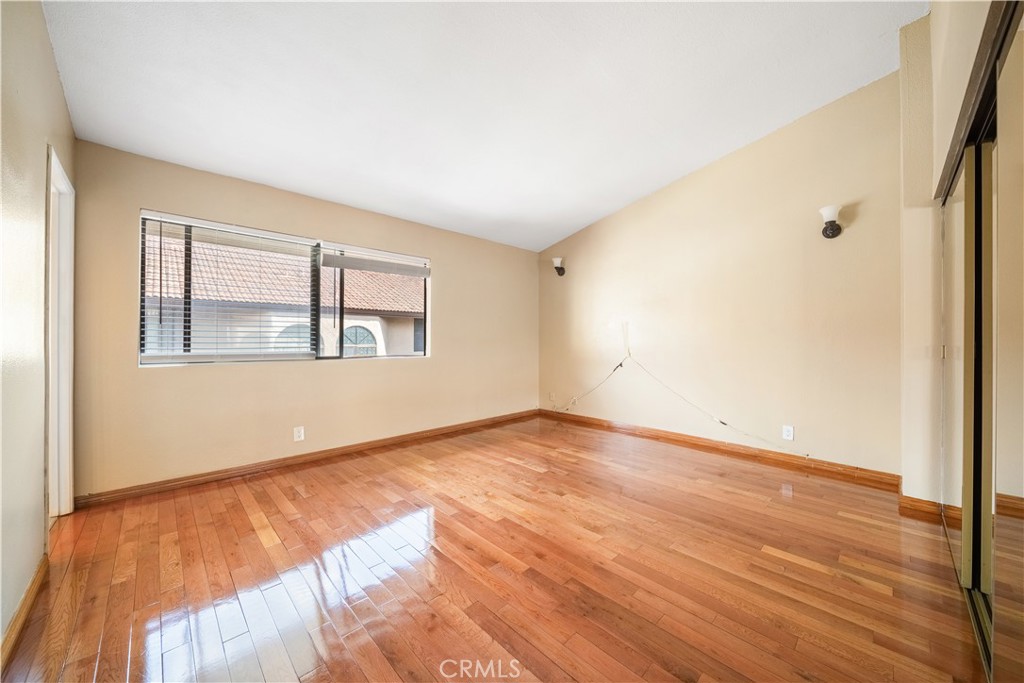 3 Saddlewood Lane Pomona, CA 91766 - Photo 24 of 40 a view of an empty room with wooden floor and a window