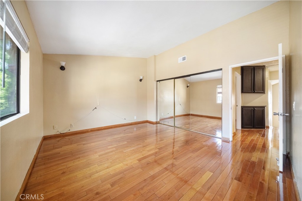 3 Saddlewood Lane Pomona, CA 91766 - Photo 25 of 40 a view of an empty room with wooden floor and a window