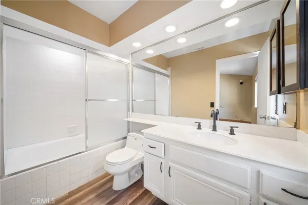 a bathroom with a toilet a sink and a mirror