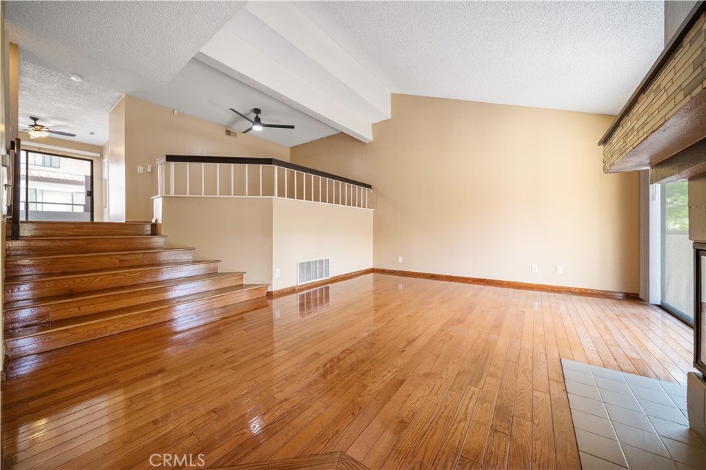 3 Saddlewood Lane Pomona, CA 91766 - Photo 3 of 40 a view of an empty room with wooden floor and a window