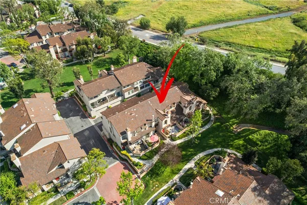 an aerial view of a house with a yard and outdoor seating