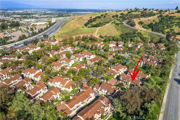 an aerial view of residential houses with outdoor space