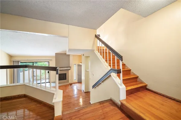 a view of entryway and hall with wooden floor