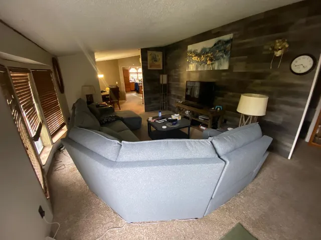 a living room with furniture and a chandelier