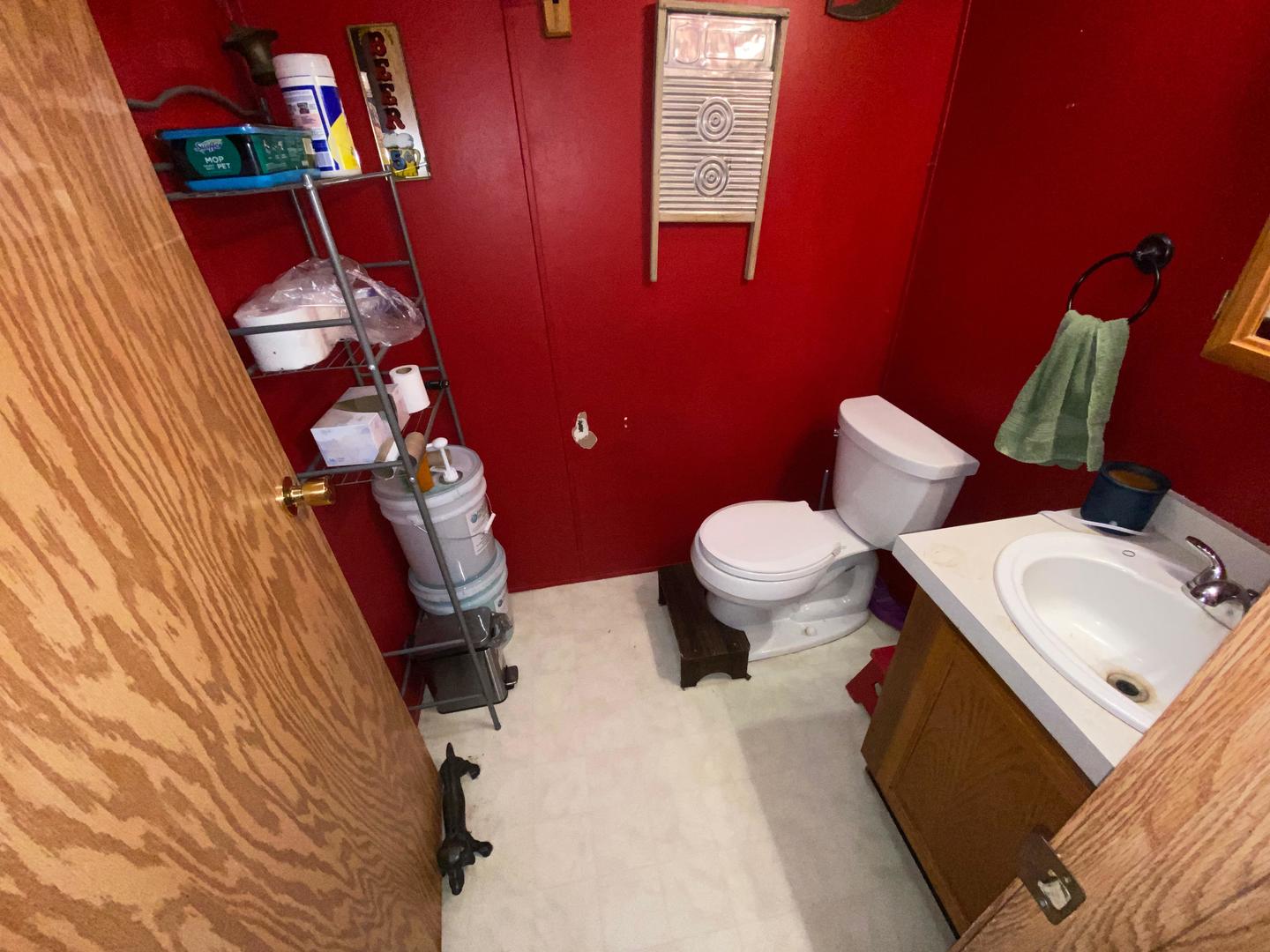 207 South Main Street Fithian, IL 61844 - Photo 8 of 23 a bathroom with a toilet sink and mirror