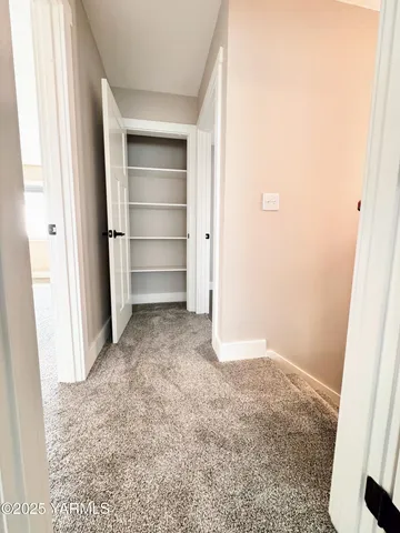 a view of an empty room and closet area