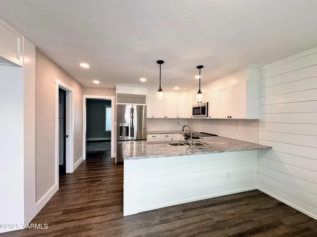 a kitchen with a sink and cabinets