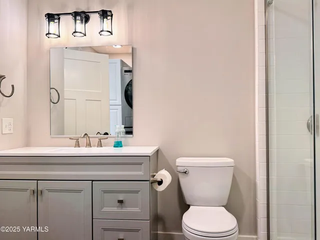 a bathroom with a sink mirror vanity and toilet