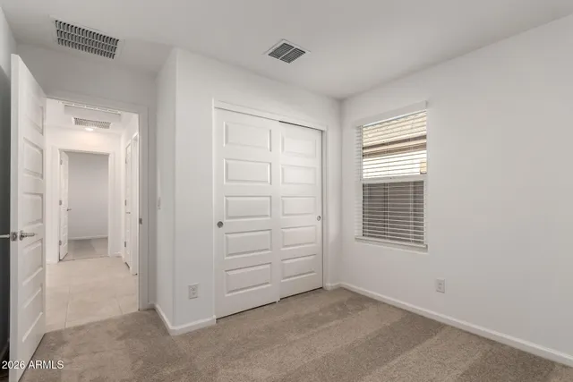 a bathroom with a granite countertop toilet sink and mirror
