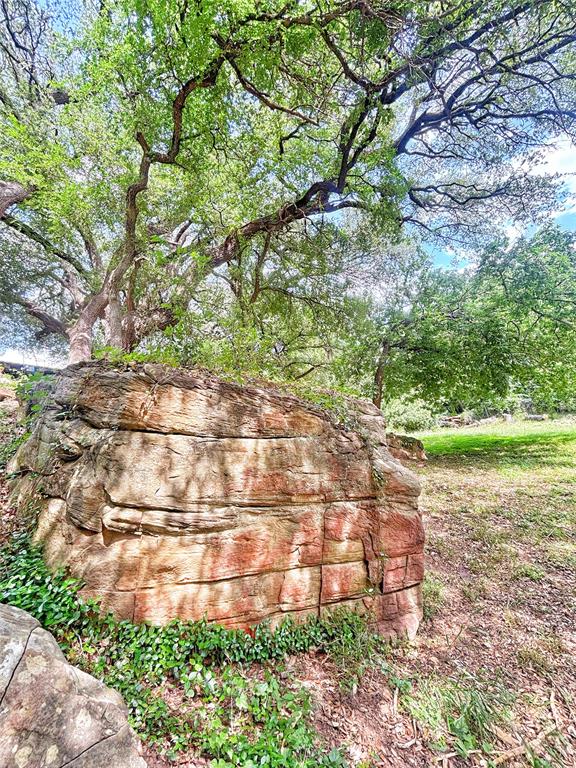 101 Riverview Road Millsap, TX 76066 - Photo 23 of 26 a backyard of a house with lots of green space and garden