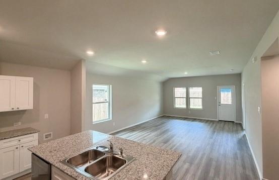 232 Blanco Drive Azle, TX 76020 - Photo 2 of 11 a kitchen with granite countertop sink stove and cabinets
