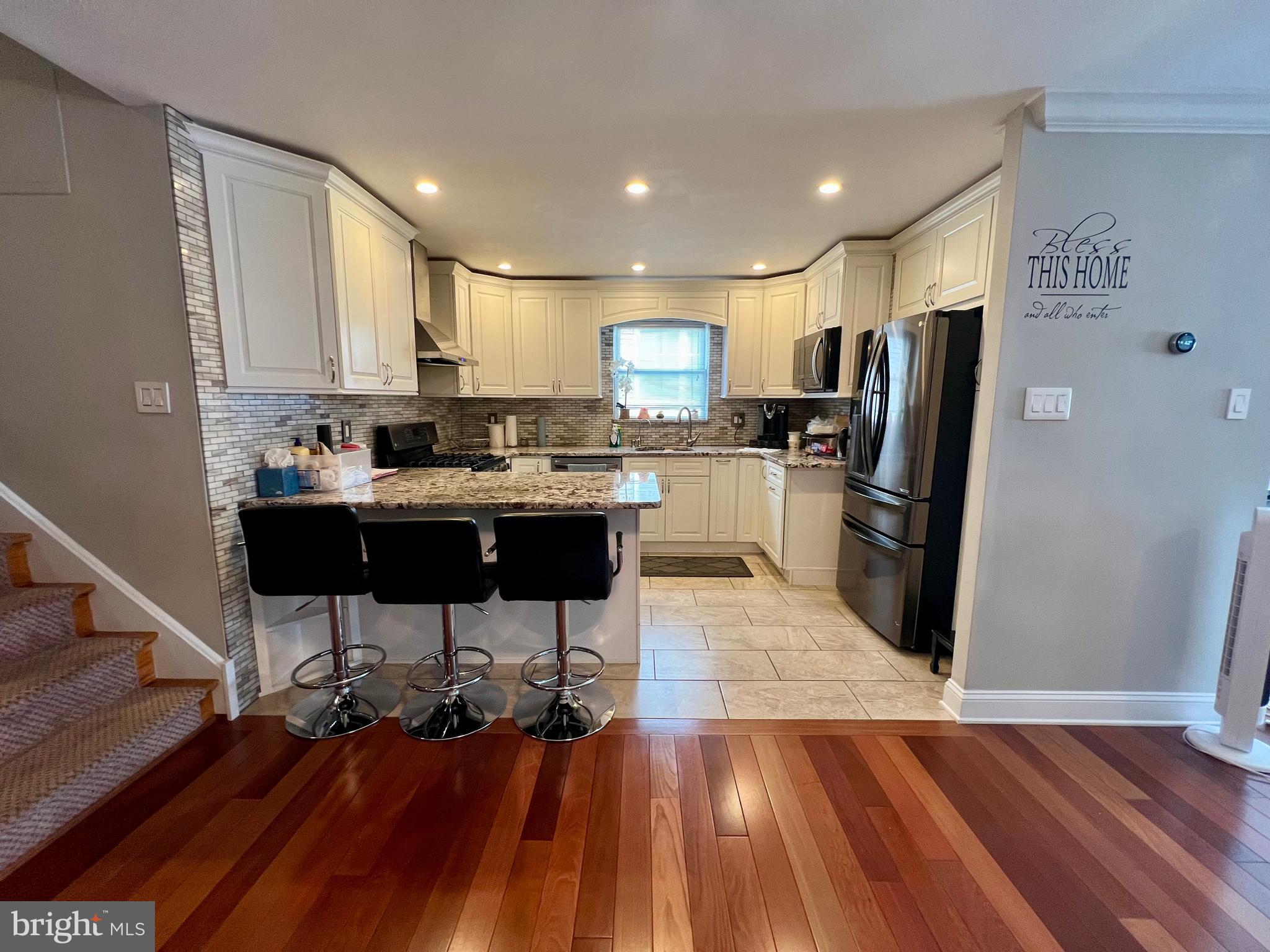 2988 Welsh Road Philadelphia, PA 19152 - Photo 11 of 38 a kitchen with stainless steel appliances kitchen island granite countertop a table chairs stove and refrigerator